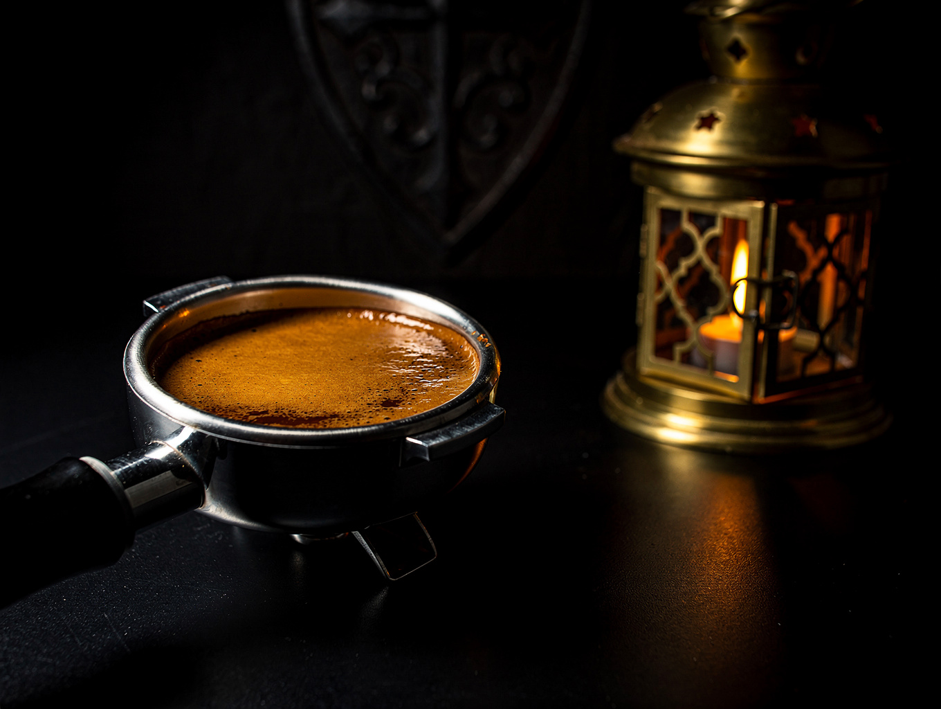 Close up of a professional espresso machine portafilter and polished chrome details